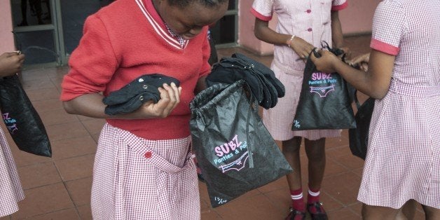 Grade 7 pupils leave with a Subz Pads & Panties pack after and educational talk about menstruation and Female reproductive system on March 7, 2015 at the Ekuthuleni Primary school in Durban. As sanitary pads are too expensive for many teenagers in Africa, NGOs try to find solutions and local products are made. AFP PHOTO/STEFAN HEUNIS (Photo credit should read STEFAN HEUNIS/AFP/Getty Images)