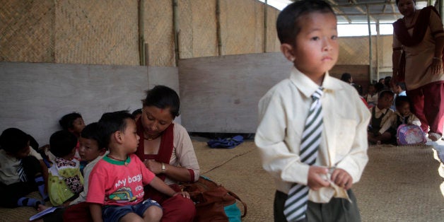 Nepalese children sit inside a makeshift school, as thousands of schools across the districts worst hit by two major earthqua