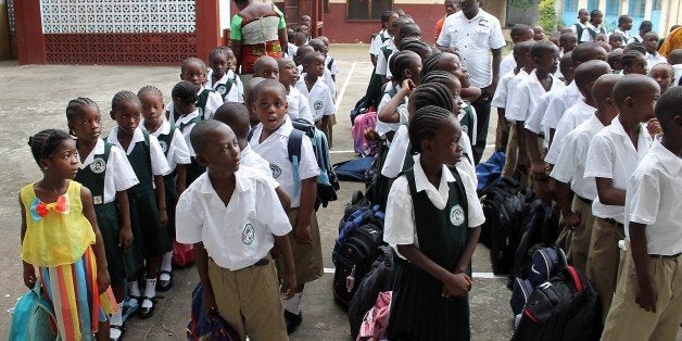 Students stand in line before heading to their classrooms at Don Bosco High School in the Liberian capital Monrovia on Februa