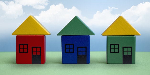 Three houses made from toy blocks