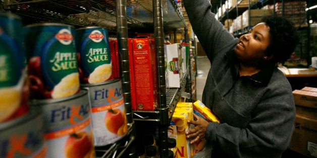 **FOR USE WITH AP LIFESTYLES** Lisa Hale, a volunteer with the Capital Area Food Bank, stocks shelves at the food bank in Washington, Monday, Oct. 27, 2008. Calls to the Capital Area Food Bank's Hunger Lifeline, an emergency food referral system in Washington, D.C., increased 248 percent in the past six months versus last year, said spokeswoman Kasandra Gunter Robinson. (AP Photo/Jacquelyn Martin)