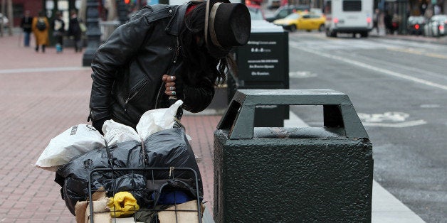 SAN FRANCISCO - JANUARY 25: A homeless man named Joe looks for recyclables in a trash can on Market Street January 25, 2010