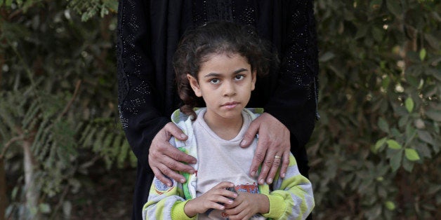 FILE - In this Saturday, Nov. 15, 2014 file photo, Hamdeya Nazmy, 43, who was forcefully subjected to female genital mutilation as a 9-year-old child poses for a photograph with her 5-year-old daughter Demyana, in Sidfa, 340 kilometers (210 miles) south of Cairo, Egypt. Nazmy has seven daughters and only one was submitted to female genital cutting. Genital mutilation involves removing all or part of the clitoris and labia minora. It is practiced in 29 countries, most of them in East and West Africa, but also in Egypt and parts of Iraq and Yemen. (AP Photo/Nariman El-Mofty, File)