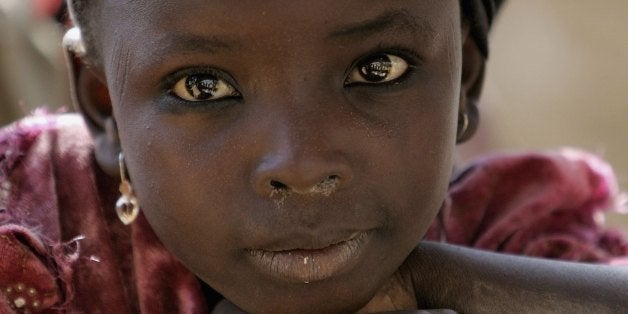 KANO, NIGERIA - NOVEMBER 29: A local girls is seen in Dawakin Kudu village on November 29, 2006 near Freetown, Sierra Leone. The village is famous for the indigo coloured dye. This is the third day of the Royal Tour to Sierra Leone and Nigeria. (Photo by Chris Jackson/Getty Images)