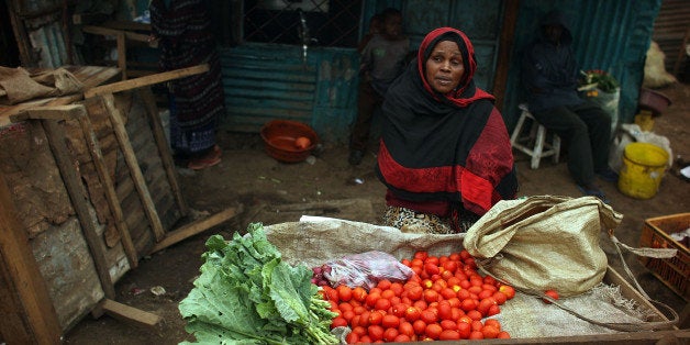 NAIROBI, KENYA - AUGUST 26: Angela Mutila sits at the vegetable stand she started with a cash grant August 26, 2009 in the Ki