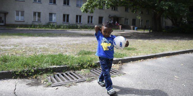 A child plays at a temporary home providing assistance for refugees in Berlin's Gatow district on August 6, 2015. Germany, overwhelmed by people fleeing war and poverty, is trying to deter asylum seekers from the Balkans, a region considered safe at least from armed conflict. AFP PHOTO / TOBIAS SCHWARZ (Photo credit should read TOBIAS SCHWARZ/AFP/Getty Images)