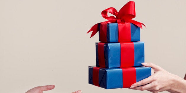 Two people exchanging gifts, close-up of hands