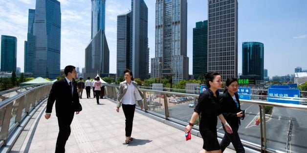 SHANGHAI, CHINA - MAY 24: White-collars walk to their lunch break in Pudong business district in Shanghai, China, on May 24, 2011. (Photo by Lucas Schifres/Getty Images)