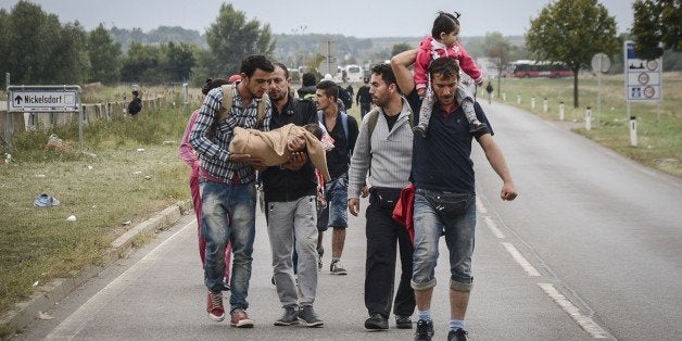 NICKELSDORF, AUSTRIA - SEPTEMBER 14 : Refugees leaving Nickelsdorf walk towards Vienna on September 14, 2015. (Photo by Hasan Tosun/Anadolu Agency/Getty Images)