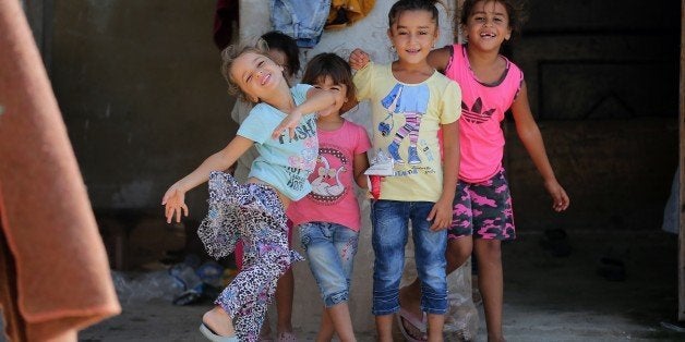 Syrian refugee children play at an unofficial refugee camp in the northern Lebanese city of Tripoli, north of the capital Beirut, on September 2, 2015. More than 13 million children are being denied an education by Middle East conflicts, the UN says, warning 'the hopes of a generation' will be dashed if they cannot return to classrooms. AFP PHOTO / JOSEPH EID (Photo credit should read JOSEPH EID/AFP/Getty Images)