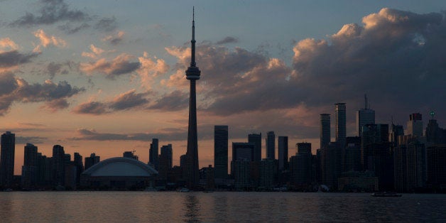 The sun sets over the Toronto skyline during the opening ceremony for the Pan Am Games, Friday, July 10, 2015. (AP Photo/Rebecca Blackwell)