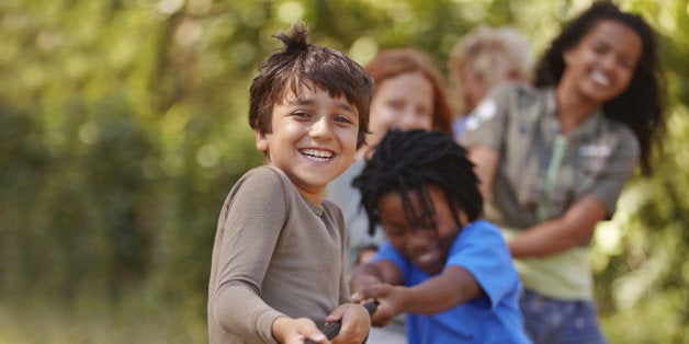 A group of kids in a tug-of-war game