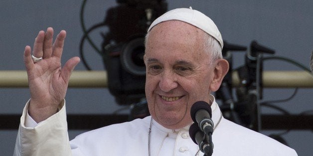 Pope Francis waves on a balcony after speaking at the US Capitol building in Washington, DC on September 24, 2015. AFP PHOTO/
