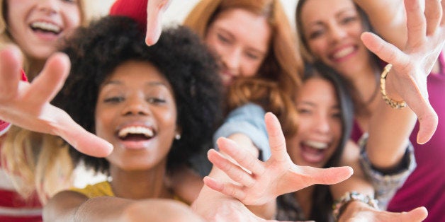 Smiling women reaching forward