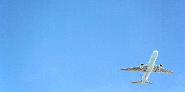 Commercial Airplane Flying Against A Blue Sky