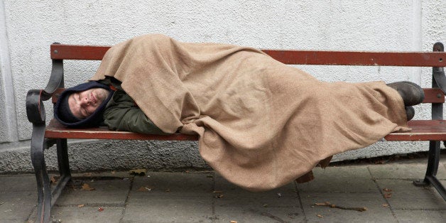 Man sleeping on bench outdoors