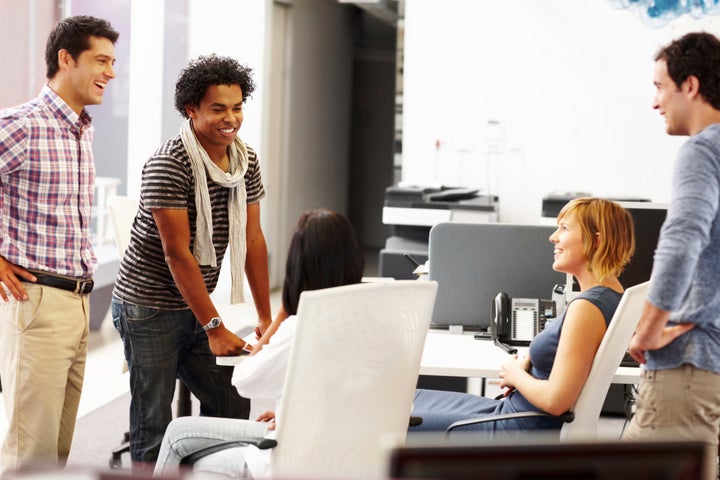 A team of vibrant and creative young designers having a casual meeting