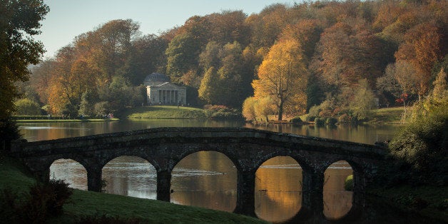 STOURHEAD, ENGLAND - NOVEMBER 02: The sun shines on trees that are displaying their autumn colours surrounding the Palladian bridge and the lakeside Pantheon at the National Trust's Stourhead on November 2, 2015 in Wiltshire, England. Following a sunnier and milder October than average, in many parts of the UK the autumn colours of trees are reaching their peak as the season moves towards winter. (Photo by Matt Cardy/Getty Images)