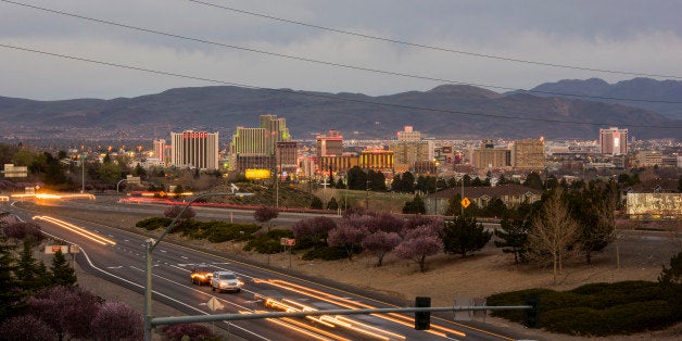 Buildings stand in the skyline of downtown as cars move along the strip in Reno, Nevada, U.S., on Friday, March 20, 2015. Ren