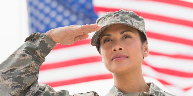 USA, New Jersey, Jersey City, Female army soldier saluting, American flag in background