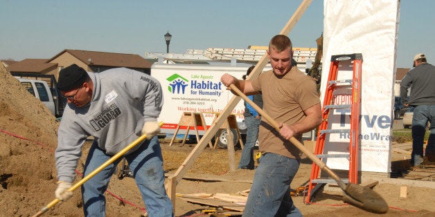 U.S. Army Staff Sgt. Kelly H. Johnson, left, and Sgt. Christopher F. King, both of the 188th Engineer Company, shovel sand into place prior to pouring concrete for a sidewalk at a house being built for Habitat for Humanity Oct. 22, 2007. Members from the North Dakota Army National Guard and Air National Guard have volunteered to "adopt" two Iraqi families who have relocated to the Fargo, N.D. area. (U.S. Air Force photo by Senior Master Sgt. David H. Lipp) www.army.mil