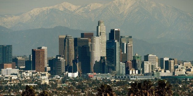 The Los Angeles city skyline stands in front of the snow covered San Gabriel Mountains after a snowstorm hit the region on De
