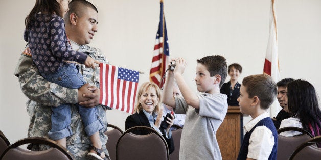 Children talking to soldier at political gathering