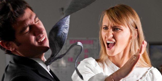 angry businesswoman is slapping across the businessman's face