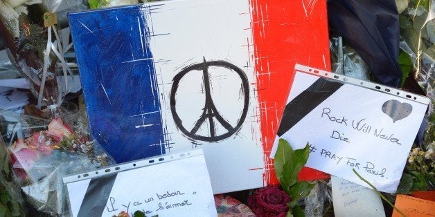 This photo taken on November 26, 2015 shows messages and artwork left at a makeshift memorial in front of the Bataclan concert hall in Paris, left in memory for victims of the November 13 terrorist attack, which resulted in 130 dead. AFP PHOTO / BERTRAND GUAY / AFP / BERTRAND GUAY (Photo credit should read BERTRAND GUAY/AFP/Getty Images)