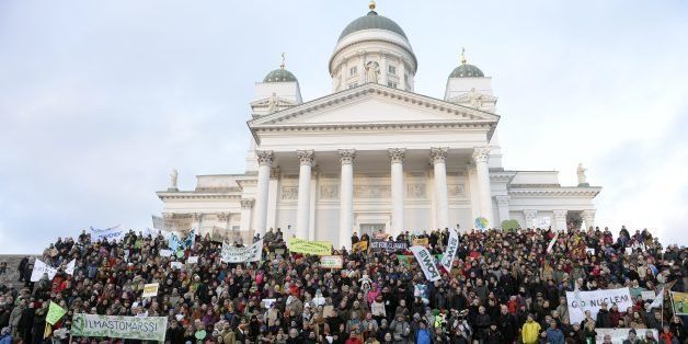 Participants gather in front of the Helsinki Cathedral during a Climate March organised by environmental NGOs on November 29, 2015 in Helsinki, Finland, on the eve of the official opening of a 195-nation UN climate summit in Paris. AFP PHOTO / Lehtikuva / VESA MOILANEN FINLAND OUT / AFP / LEHTIKUVA / VESA MOILANEN (Photo credit should read VESA MOILANEN/AFP/Getty Images)