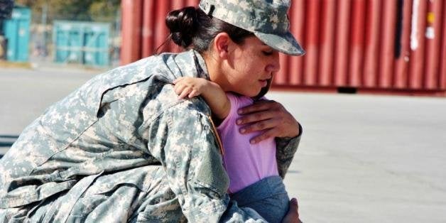 A Soldier and Mother embraces her daughter during the 125th Forward Support Company, 1st Battalion, 94th Field Artillery Regi