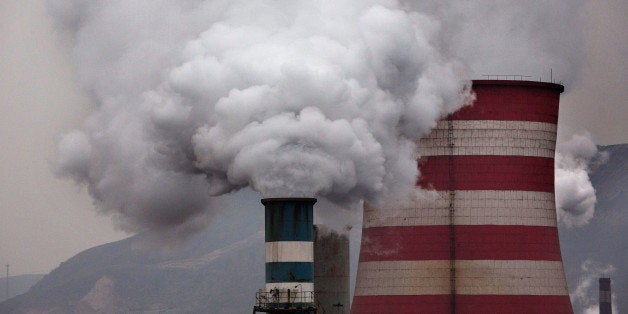 HEBEI, CHINA - NOVEMBER 19: Smoke billows from smokestacks and a coal fired generator at a steel factory on November 19, 201