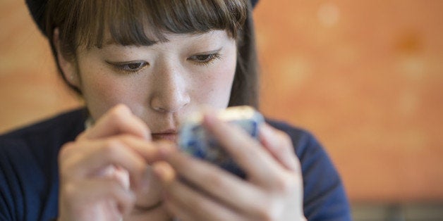 Young woman using mobile phone.