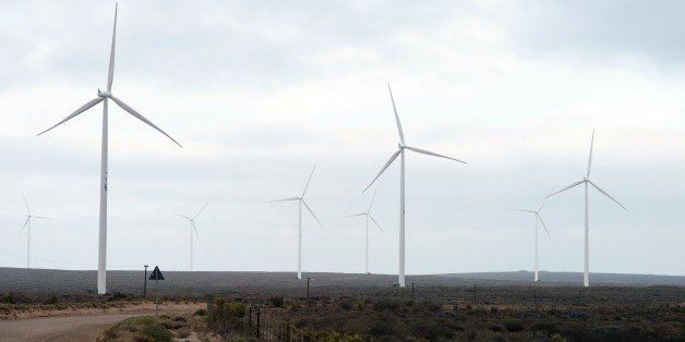 TO GO WITH AFP STORY BY PIERRE DONADIEUThis photo taken on November 6, 2015 shows a wind turbines turning in the wind at the Sere Wind farm, close to Vredendal, about 350 km from Cape Town. The Sere wind farm, which consists of 46 turbines, each standing 115m above the ground and producing 2,3 megawatts of electricity, is managed by Eskom, the South African government parasatal charged with electricity supply, and was built by Siemens. Heavily reliant on coal-fired electricity, South Africa is launching ambitious new projects aimed at diversifying its energy sources and avoiding the regular power cuts that have hobbled the economy in recent years. Solar and wind energy plants are mushrooming across the country while the government is planning a huge -- and controversial -- expansion of nuclear power. AFP PHOTO / RODGER BOSCH / AFP / RODGER BOSCH (Photo credit should read RODGER BOSCH/AFP/Getty Images)