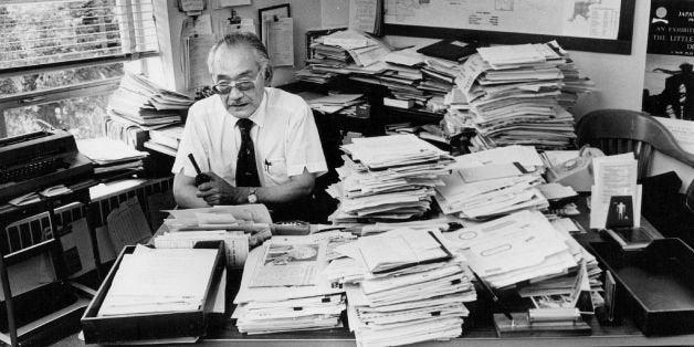 SEP 17 1981, SEP 20 1981, SEP 22 1981; Minoru Yasui sits behind office desk piled high with papers; *****he put in 2,185 hours of overtime, with no extra pay -- since he is an appointed official. He may work to midnight.; (Photo By Dave Buresh/The Denver Post via Getty Images)