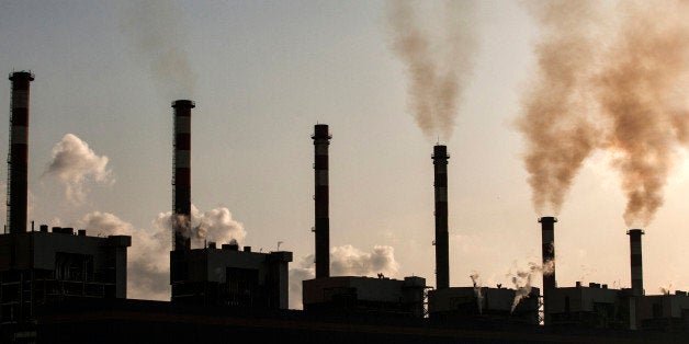 Smoke rises from silhouetted chimneys at the Bin Qasim Power Station II plant, operated by K-Electric Ltd., in the Bin Qasim