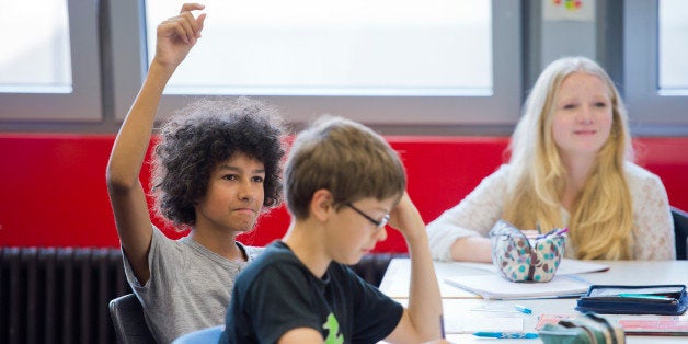 GOETTINGEN, GERMANY - SEPTEMBER 19: Posed scene: student raising his hand during a class at the Georg-Christoph-Lichtenberg-Gesamtschule IGS Goettingen on September 19, 2014, in Goettingen, Germany. The Georg-Christoph-Lichtenberg-Gesamtschule is a comprehensive school. Photo by Michael Gottschalk/Photothek via Getty Images)***Local Caption***