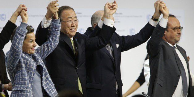 (L-R) Executive Secretary of the United Nations Framework Convention on Climate Change (UNFCCC) Christiana Figueres, Secretary General of the United Nations Ban Ki Moon, Foreign Affairs Minister and President-designate of COP21 Laurent Fabius, and France's President Francois Hollande raise hands together after adoption of a historic global warming pact at the COP21 Climate Conference in Le Bourget, north of Paris, on December 12, 2015. Envoys from 195 nations on December 12 adopted to cheers and tears a historic accord to stop global warming, which threatens humanity with rising seas and worsening droughts, floods and storms. AFP PHOTO / FRANCOIS GUILLOT / AFP / FRANCOIS GUILLOT (Photo credit should read FRANCOIS GUILLOT/AFP/Getty Images)