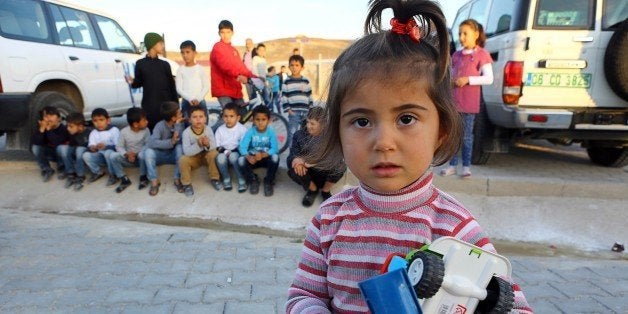 Syrian Refugee children are pictured at the refugee camp in Osmaniye on December 15, 2015. Turkey is home to at least 2.2 million Syrian refugees after President Recep Tayyip Erdogan declared an open door policy at the onset of the Syrian crisis. Out of the 2.2 million Syrians in Turkey, only around 260,000 stay in camps near the Syrian border and the remaining vast majority is scattered throughout the country including big cities like Istanbul. Education is one of the main challenges. / AFP / ADEM ALTAN / TO GO WITH AFP STORY BY FULYA OZERKAN (Photo credit should read ADEM ALTAN/AFP/Getty Images)