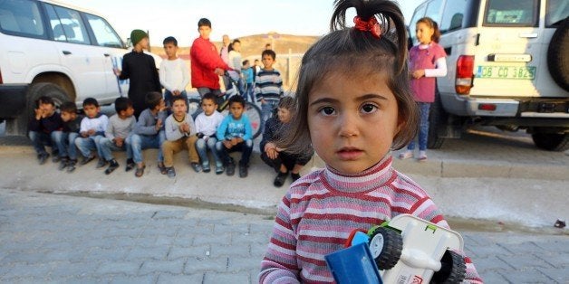 Syrian Refugee children are pictured at the refugee camp in Osmaniye on December 15, 2015.Turkey is home to at least 2.2 million Syrian refugees after President Recep Tayyip Erdogan declared an open door policy at the onset of the Syrian crisis. Out of the 2.2 million Syrians in Turkey, only around 260,000 stay in camps near the Syrian border and the remaining vast majority is scattered throughout the country including big cities like Istanbul. Education is one of the main challenges. / AFP / ADEM ALTAN / TO GO WITH AFP STORY BY FULYA OZERKAN (Photo credit should read ADEM ALTAN/AFP/Getty Images)