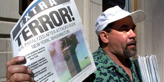 Newspaper vendor Carlos Mercado sells the 'Extra' editon of the Chicago Sun-Times printed 11 September, 2001, after the terrorist attacks on the United States. Two hijacked airplanes crashed into the World Trade Center twin towers in New York while one hijacked plane later crashed at the Pentagon in Washington, DC, with another plane crashing 80 miles outside of Pittsburgh, Pennsylvania. AFP PHOTO/Scott OLSON (Photo credit should read SCOTT OLSON/AFP/Getty Images)