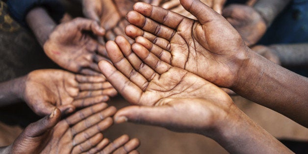 'Poor African children keeping their hands up - asking for help. Many African children suffer from poverty - 20%25 of Africaa
