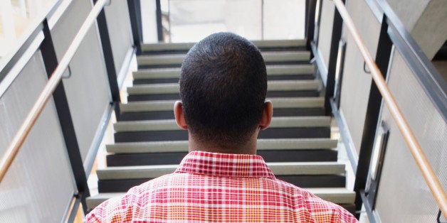 Man in wheelchair looking at stairs