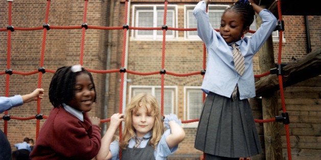 Group of school kids playing on a wooden climbing frame, South London, UK, 2000s. (Photo by: PYMCA/UIG via Getty Images)