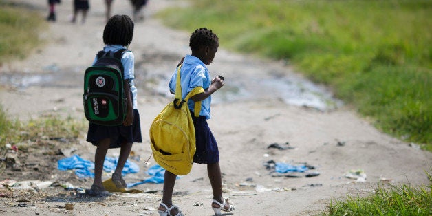 Beira, Mozambique - September 28: Girls with backpacks walk along a path on September 28, 2015 in Beira, Mozambique. (Photo by Thomas Trutschel/Photothek via Getty Images)