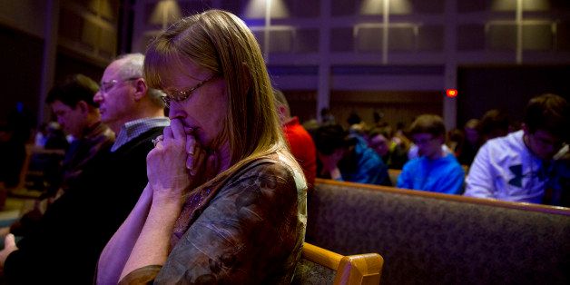 KALAMAZOO, MI - FEBRUARY 21: People gather and pray at Center Point Church following a mass shooting on February 21, 2016 in Kalamazoo, Michigan. Authorities said that a shooter who killed six people and injured two others was an Uber driver who appears to have gunned down people at random during a four-hour rampage in the parking lots of a western Michigan apartment complex, a car dealership and a Cracker Barrel store on February 21, 2016 in Kalamazoo, Michigan. (Photo by Tasos Katopodis/Getty Images)