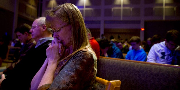 KALAMAZOO, MI - FEBRUARY 21: People gather and pray at Center Point Church following a mass shooting on February 21, 2016 i