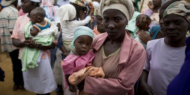 Mothers carrying their emaciated children line up at the WFP and Save the Children Clinic for emergency food and medical care