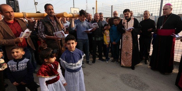 Iraqi Christians, who fled the violence in the northern city of Mosul after Islamic State (IS) group militants took control of the area, attend a weekly prayer at the Ashti camp in Arbil, the capital of the autonomous Kurdish region of northern Iraq, on March 4, 2016. / AFP / SAFIN HAMED (Photo credit should read SAFIN HAMED/AFP/Getty Images)