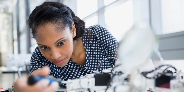 Focused engineer assembling robot